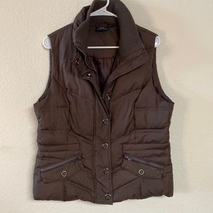 Down quilted vest. Zips and snaps up front and double pockets.